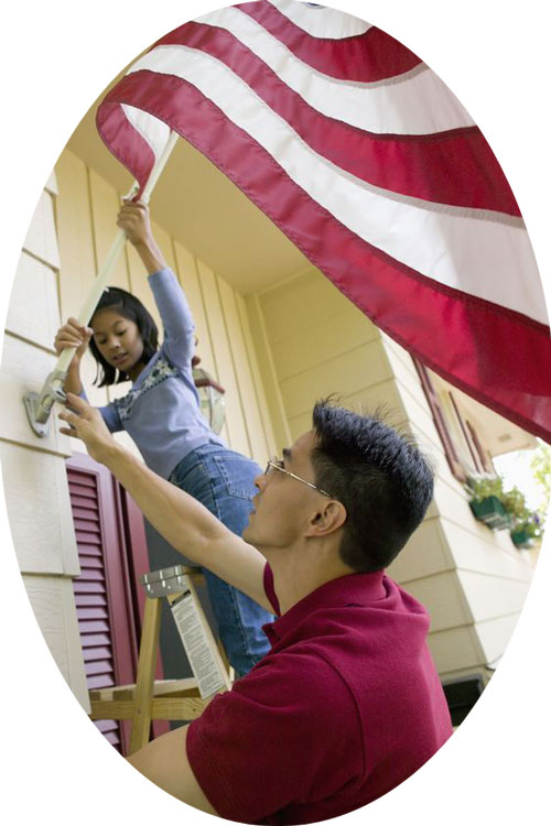 new American raising flag on front porch